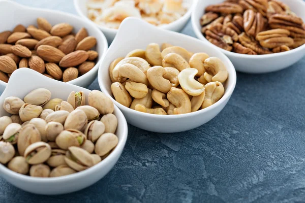 Variety of nuts in small bowls — Stock Photo, Image