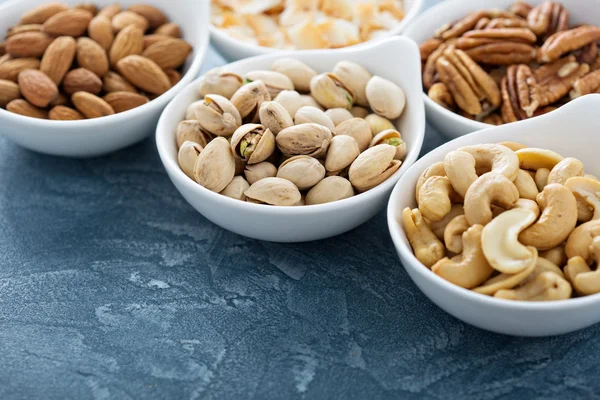 Variety of nuts in small bowls — Stock Photo, Image