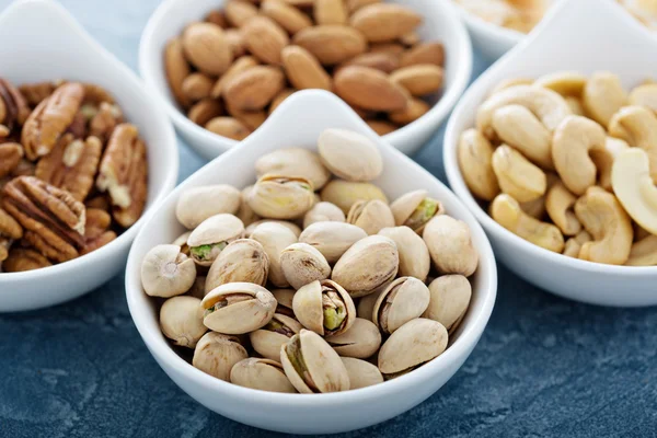 Variety of nuts in small bowls — Stock Photo, Image