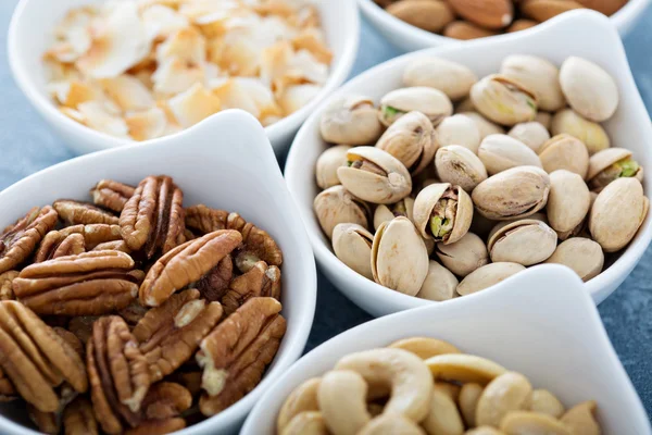 Variety of nuts in small bowls — Stock Photo, Image