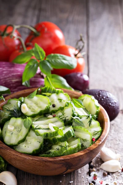 Pickled cucumber in a rustic wooden bowl — Stock Photo, Image