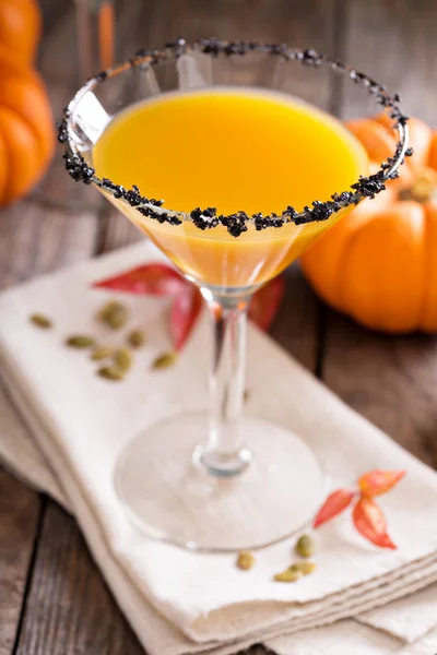 Pumpkin martini cocktail with black salt rim — Stock Photo, Image