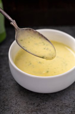 Bearnaise sauce in a small bowl clipart