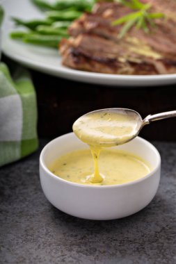 Bearnaise sauce in a small bowl clipart