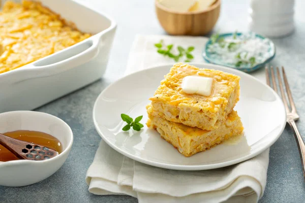 Cheesy cornbread freshly baked served with butter — Stock Photo, Image