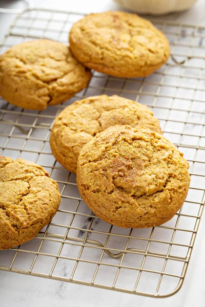 Soft pumpkin cookies on a cooling rack, fall baking — Stock Photo, Image