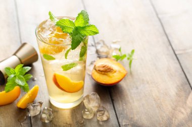 Taze nane, limon ve şeftali dilimli şeftalili mojito kokteyli.