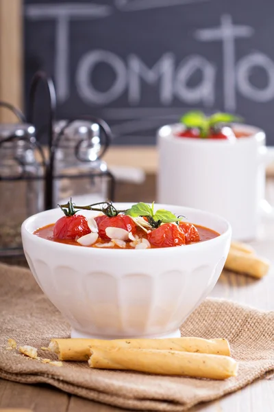 Tomato soup with baked tomatoes and breadsticks — Stock Photo, Image