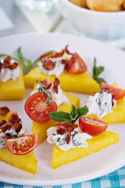 Polenta appetizers with ricotta and bacon — Stock Photo, Image