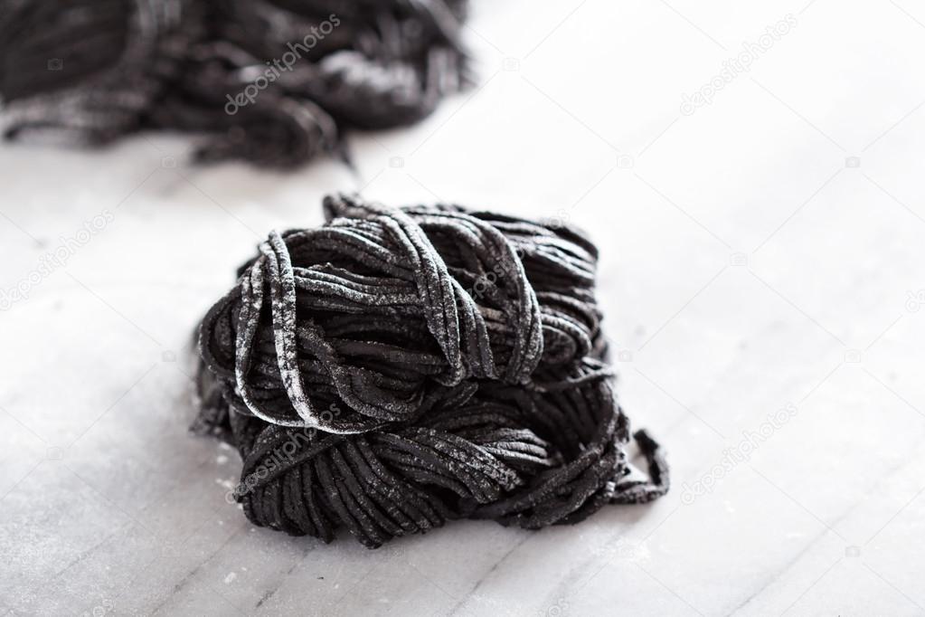 Squid ink homemade pasta on marble