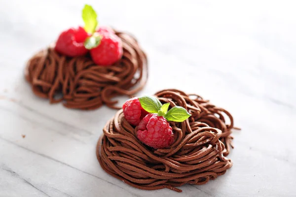 Raw chocolate pasta nests with raspberry — Stock Photo, Image