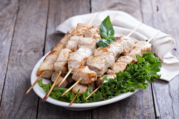 Pork kebabs with fresh salad leaves — Stock Photo, Image