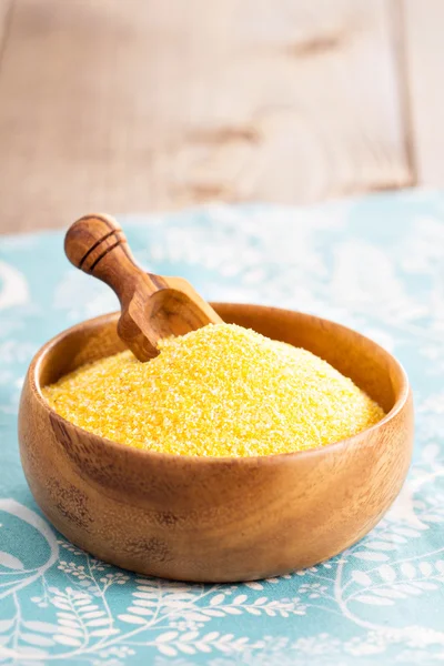 Dry raw cornmeal in wooden bowl — Stock fotografie