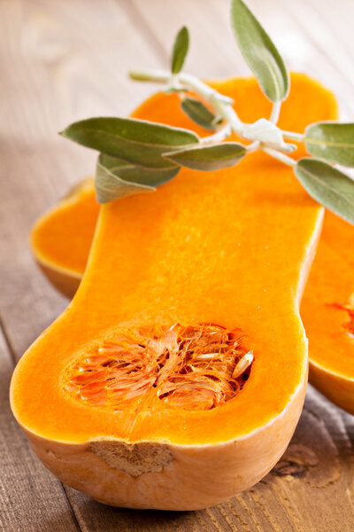 Raw butternut squash halved with sage