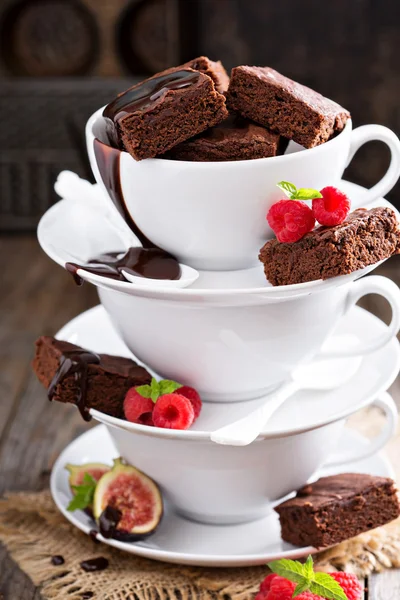 Brownies ve skládaných hrnečků s čokoládovou omáčkou Stock Obrázky