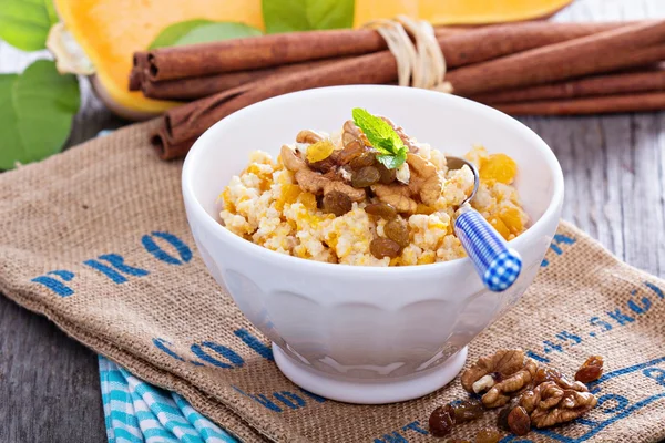 Pumpkin millet porridge with nuts and raisins — Stock Image Pumpkin millet porridge with nuts and raisins Royalty Free Stock Images
