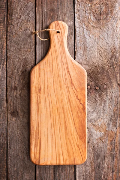 Wooden rustic background with a cutting board — Stock Photo, Image