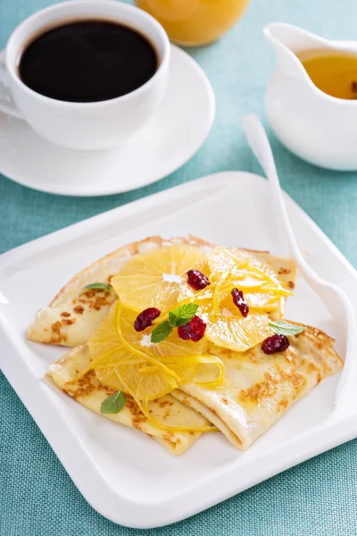 Thin crepes with citrus sauce and dried cranberry — Stock Photo, Image