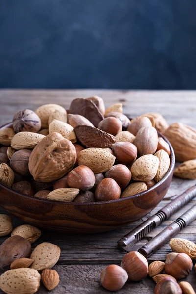 Variety of nuts with shells in a bowl — Stock Photo, Image