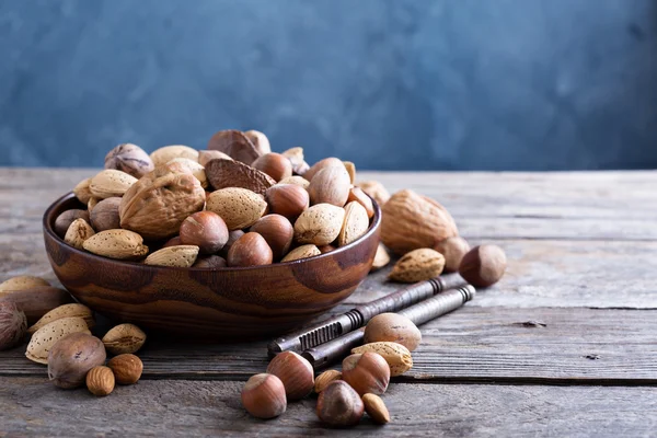 Variety of nuts with shells in a bowl — Stock Photo, Image