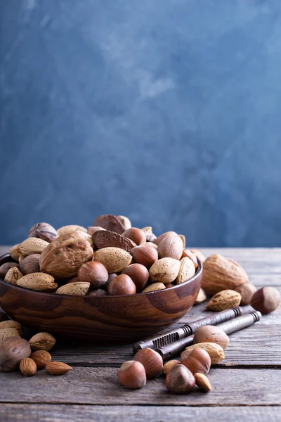 Variety of nuts with shells in a bowl — Stock Photo, Image