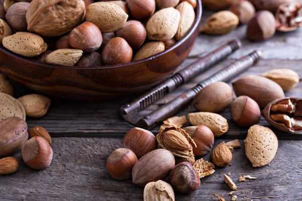 Variety of nuts with shells in a bowl — Stock Photo, Image