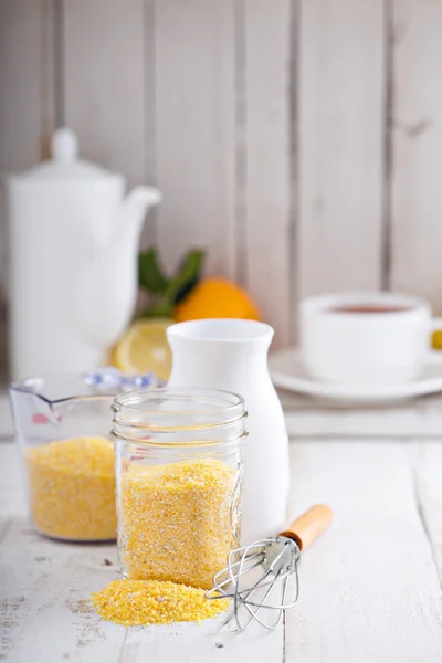 Raw cornmeal with a whisk — Stock Photo, Image