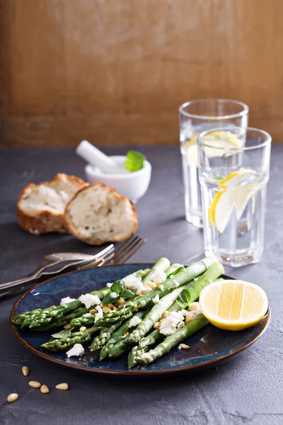 Warm salad with asparagus, feta cheese and lemon — Stock Photo, Image