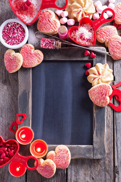 Sevgililer günü kurabiyeleri yazı tahtası çevresinde — Stok fotoğraf