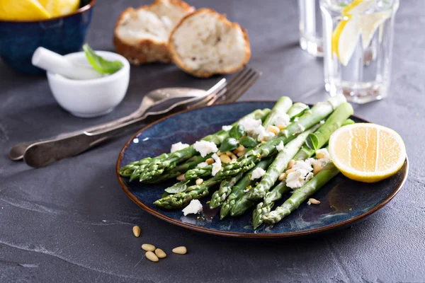 Warm salad with asparagus, feta cheese and lemon — Stock Photo, Image