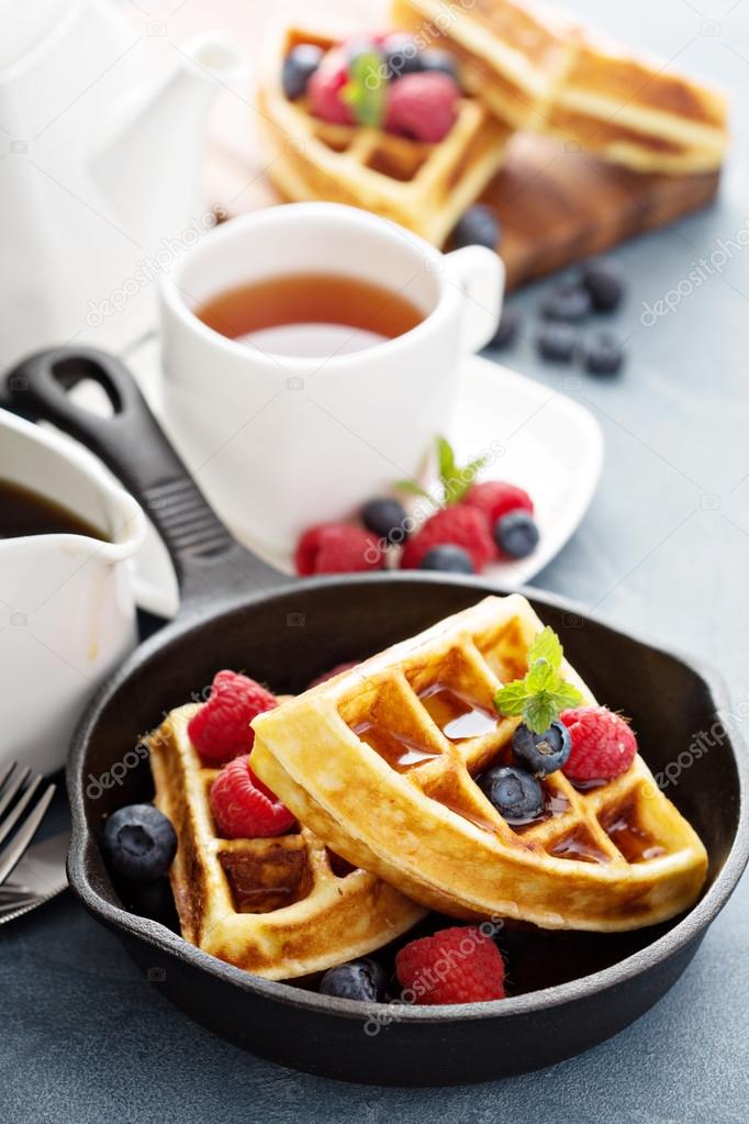 Freshly baked waffles with berries for breakfast
