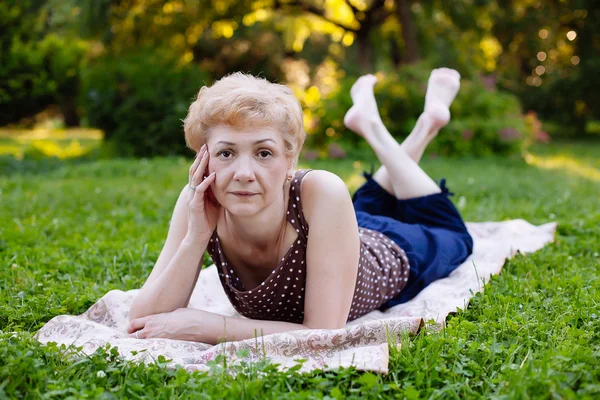 Portret van middelste leeftijd vrouw die lacht in het park — Stockfoto