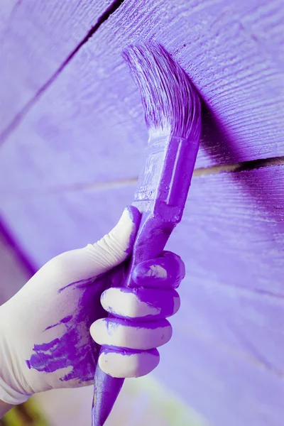 Hand painting violet wooden wall — Stock Photo, Image