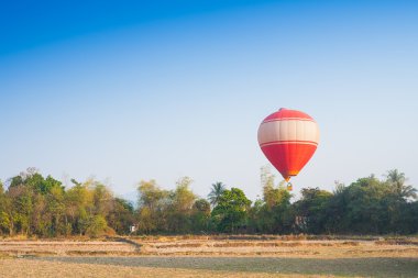 Hot air balloon on sky in Laos clipart