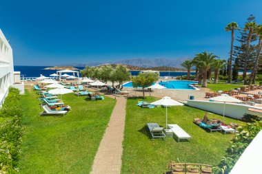 Agios Nikolaos, Yunanistan - 30 Temmuz 2012: güneş yarasa alarak turist