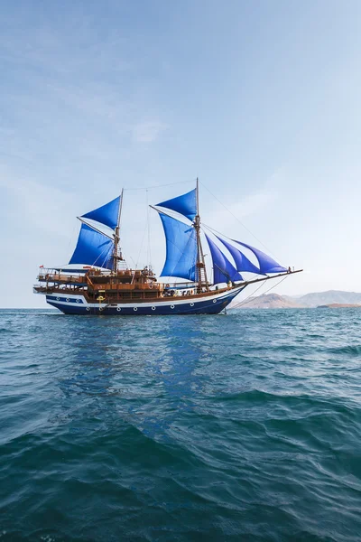 Vintage Wooden Ship with Blue Sails — Stock Photo, Image