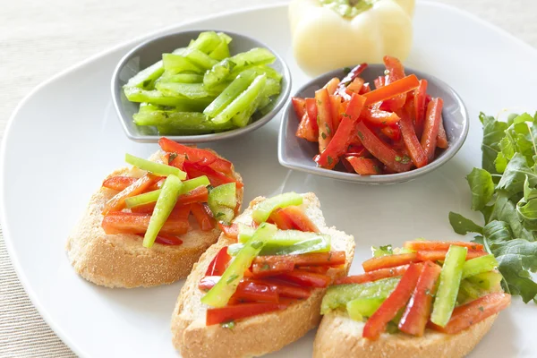 Crostini with red and green pepper — Stock Photo, Image