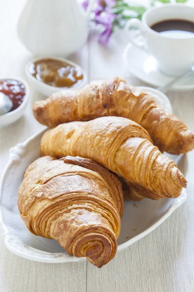 Croissants on table with jam and coffee — Stock Photo, Image