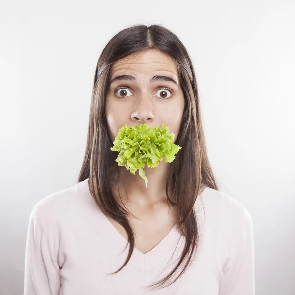 Young woman with lettace in her mouth — Stock Photo, Image