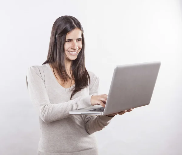 Beautiful young woman using a laptop computer Stock Photo