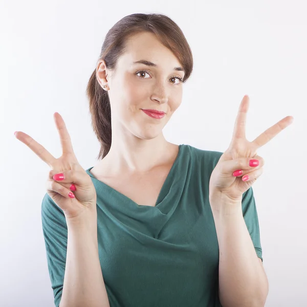 Woman making victory signs by hands — Stock Photo, Image