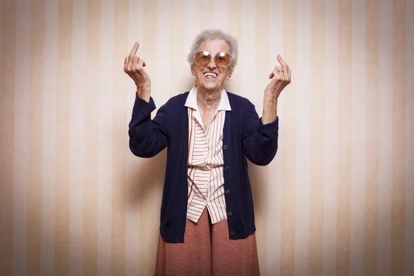 Lady making middle fingers signs — Stock Photo, Image