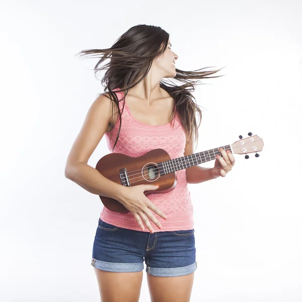 Junge schöne Frau spielt Ukulele und hat Spaß — Stockfoto