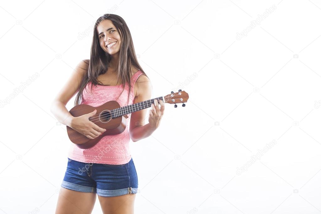 young beautiful brunette woman playing ukulele