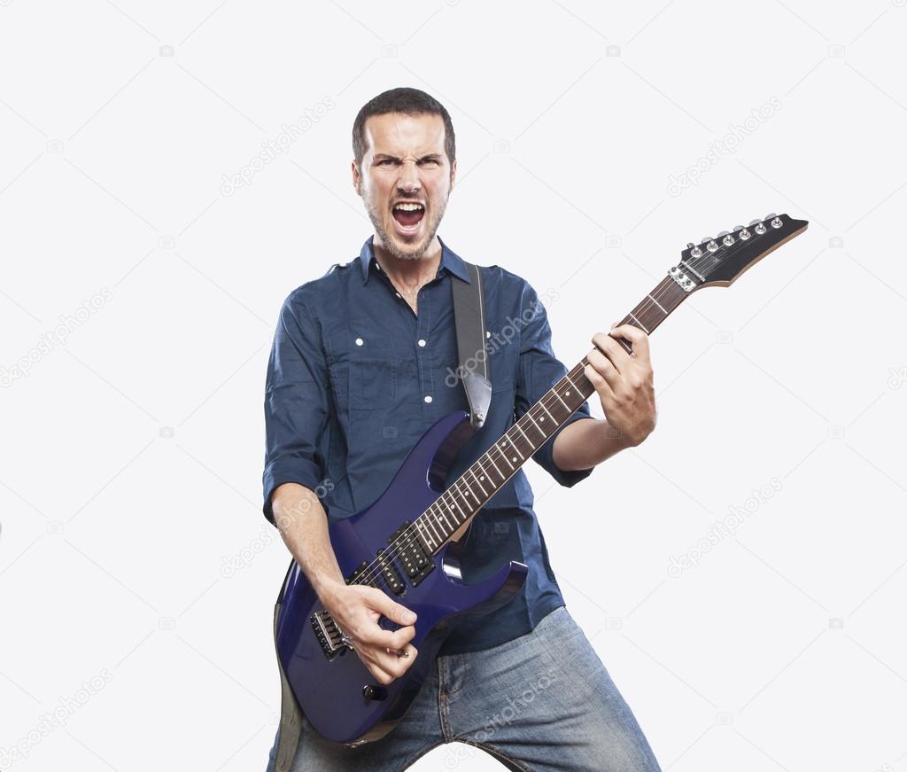 Young man playing electric guitar — Stock Photo ...