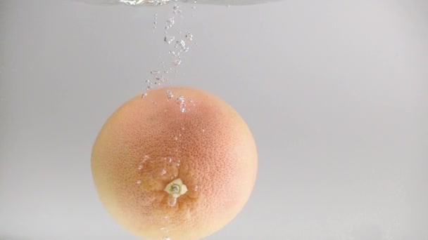 Pomelo Fresco Cae Agua Con Salpicaduras Burbujas Cámara Lenta Frutos — Vídeos de Stock