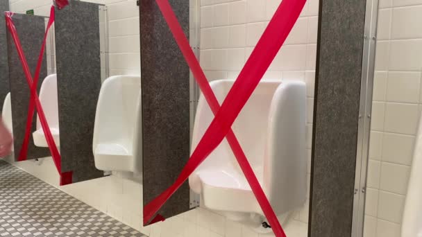 Man Walks Up to Urinal with Others Taped Off — Stok Video