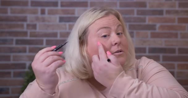 Γυναίκα επιδεικνύει eyeliner στην κάμερα για τα μέσα κοινωνικής δικτύωσης — Αρχείο Βίντεο