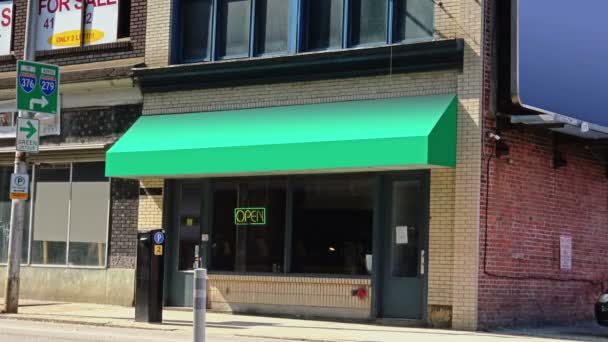 A generic, unbranded storefront with a green awning in a city.  Signage has been removed for easy customization and general stock use. — Stock Video