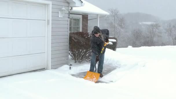 4K Man Shovels Driveway 3978 — Stock Video